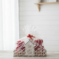 Gift wrapped in a decorative box with cellophane on a white surface.
