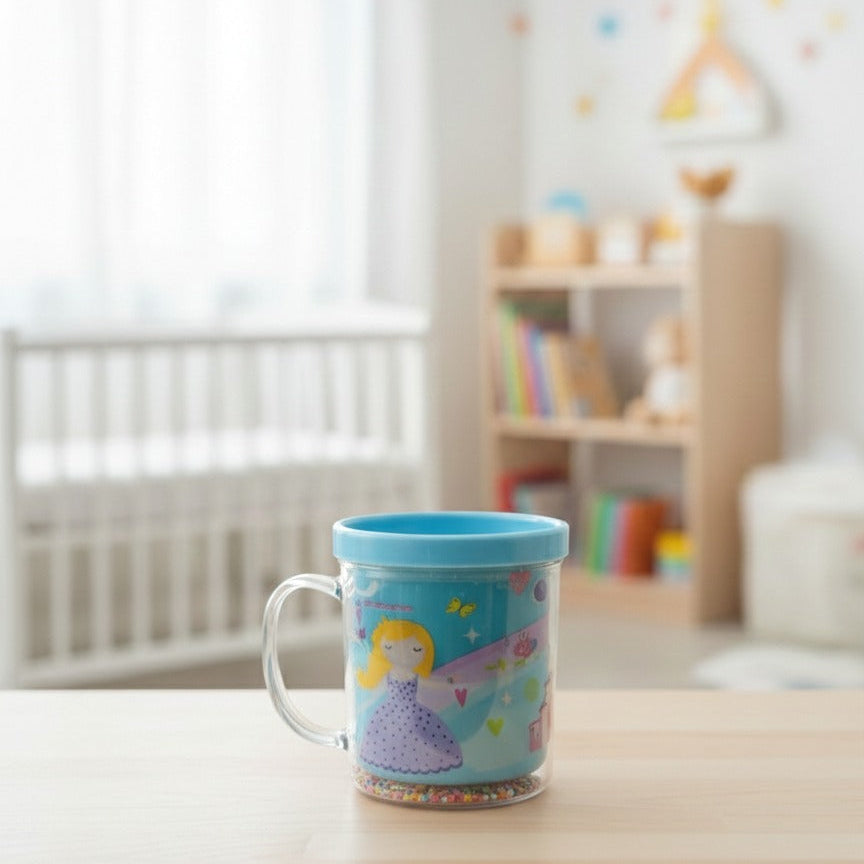 Children's blue cup with fairy design on a table in a room with toys and furniture.