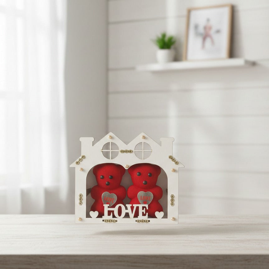 Red heart-shaped boxes in a decorative white box on a light wooden surface with a blurred background.